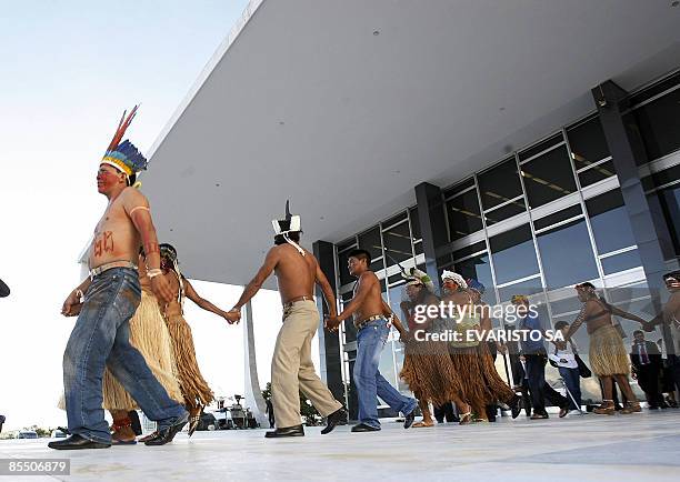 Brazilian natives from the Raposa Serra do Sol indigenous reserve in the Amazon state of Roraima, dance and sing in front of the Supreme Court in...