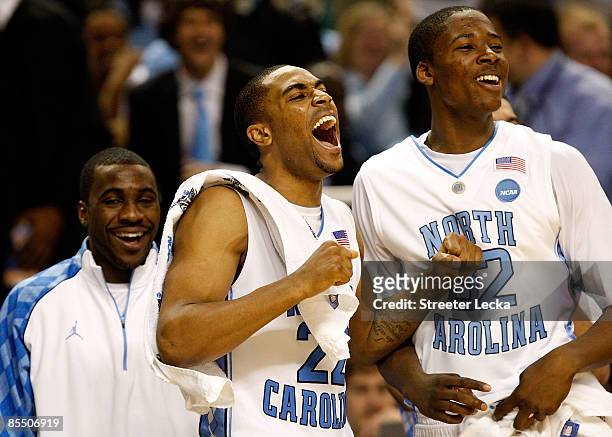 Ty Lawson, Wayne Ellington and Ed Davis of the North Carolina Tar Heels cheer from the bench in the final minutes of their 101-58 win over the...