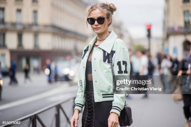Model Josephine Skriver with pigtails wearing a mint leather jacket, overknee boots, Chanel bag, sheer black dress is seen outside Balmain during...