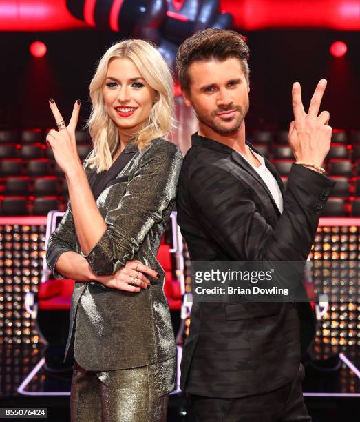 Moderators Lena Gercke, wearing a golden suit from Karl Lagerfeld, and Thore Schoelermann attend the 'The Voice of Germany' photo call on September...