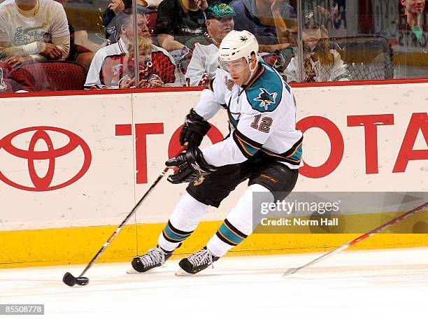 Patrick Marleau of the San Jose Sharks tries to gain control of the puck against the Phoenix Coyotes on March 17, 2009 at Jobing.com Arena in...