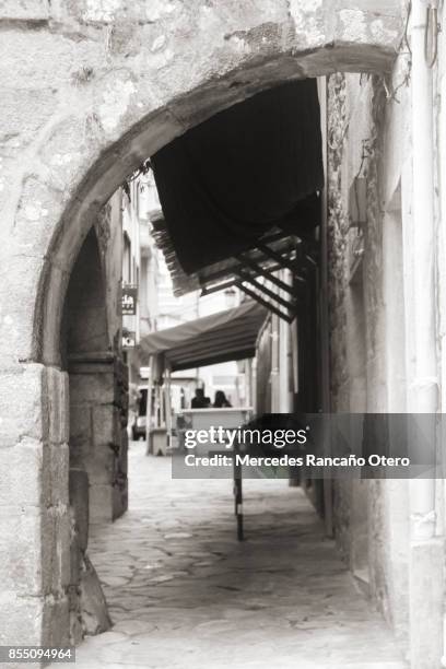 half stone arch, street in noia, galicia, spain. - noia stock pictures, royalty-free photos & images