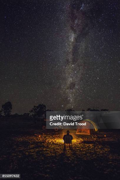 camping in a tent under the milky way. - australia fire stock-fotos und bilder