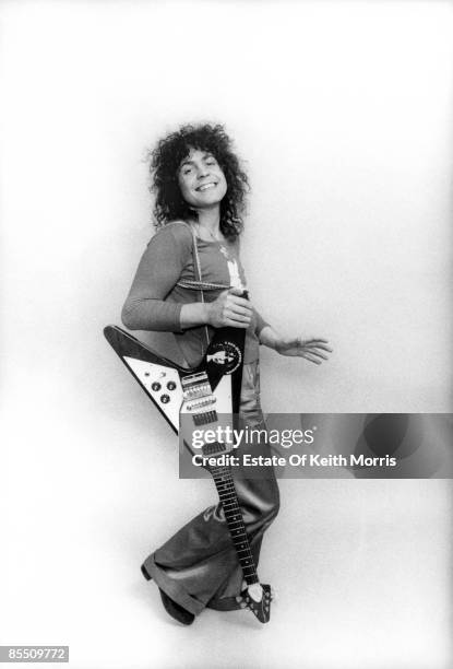 Photo of Marc BOLAN and T REX; posed, studio, with Gibson Flying V guitar