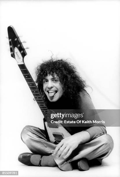 Photo of Marc BOLAN and T REX; studio, posed with Gibson Flying V guitar