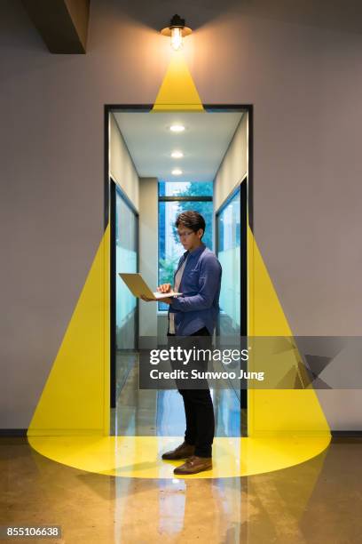 creative professional working on a project in modern office - yellow shirt stock pictures, royalty-free photos & images