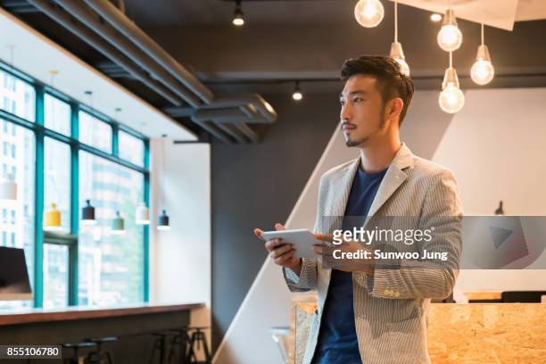 portrait of creative professional in modern office - korean man stockfoto's en -beelden