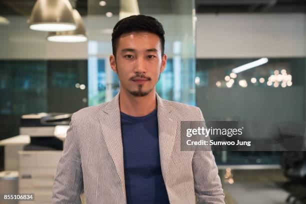 portrait of creative professional in modern office - korean man 個照片及圖片檔