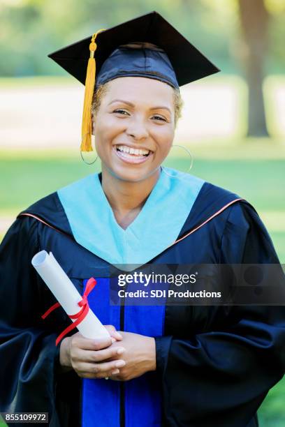 woman receives advanced degree from a university - winner sash stock pictures, royalty-free photos & images