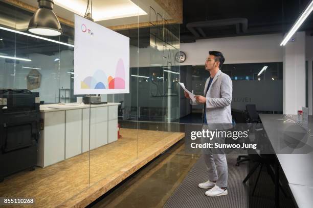 businessman watching a creative graph in modern office - presentation materials stock pictures, royalty-free photos & images