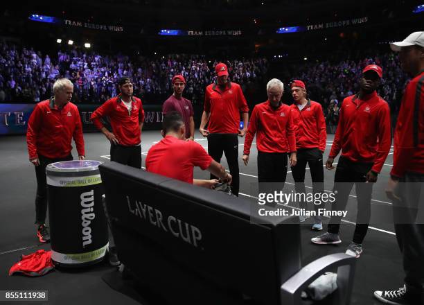Nick Kyrgios is surrounded by a dejected Team World after his loss to Roger Federer of Team Europe during the final day of the Laver Cup at the O2...