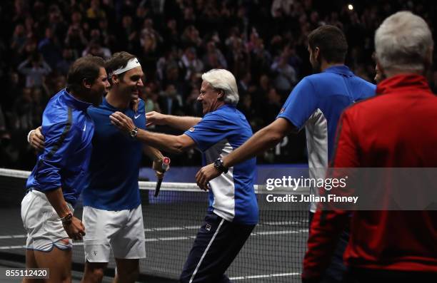 Roger Federer of Team Europe celebrates defeating Nick Kyrgios of Team World with Captain Bjorn Borg and Rafael Nadal during the final day of the...