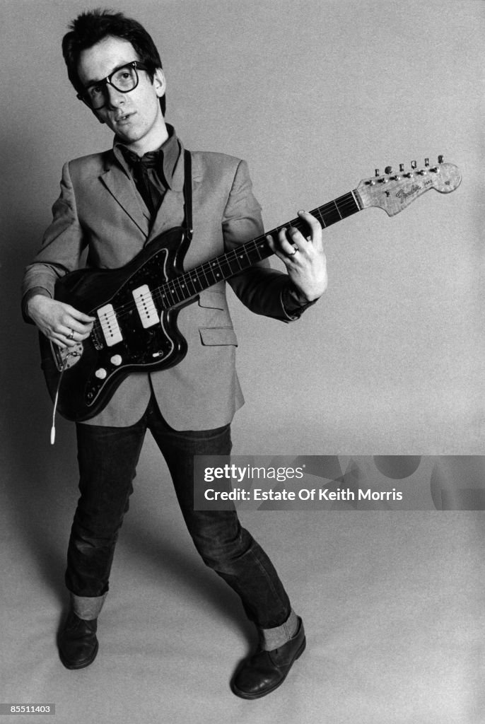Photo of Elvis COSTELLO; studio, posed - "My Aim is True" cover... News