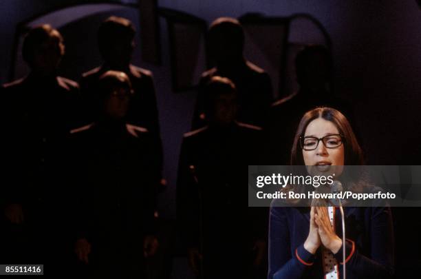 Greek singer Nana Mouskouri performs on the set of a pop music television show in London circa 1970.