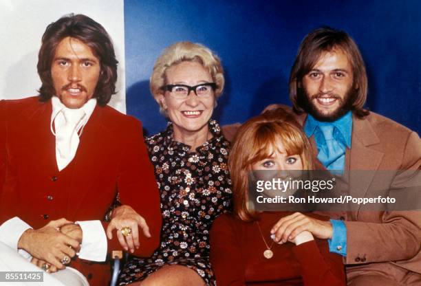 From left, Barry Gibb, mother Barbara Gibb, Scottish singer Lulu and husband Maurice Gibb of the Bee Gees posed backstage in London circa 1970.