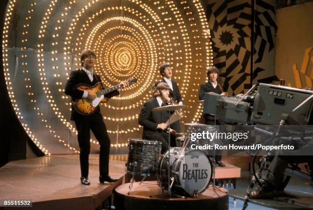 English rock and pop group The Beatles perform on the set of a pop music television show in London on 16th June 1966. Members of the band are, from...