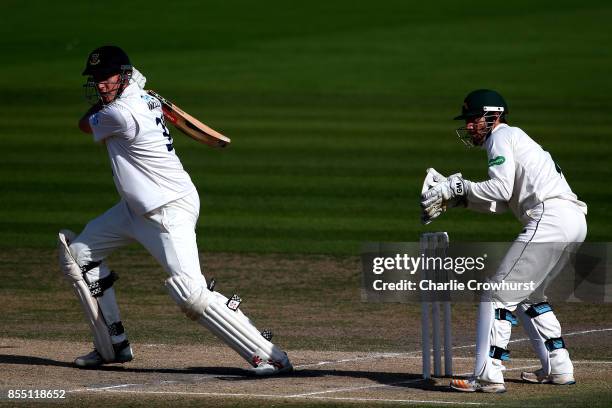 Luke Wells of Sussex hits out while Nottingham keeper Chris Read looks on during day four of the Specsavers County Championship Division Two match...