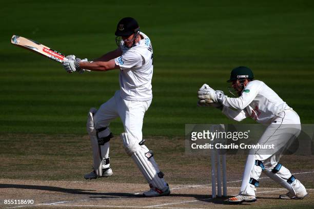 Luke Wells of Sussex hits out while Nottingham keeper Chris Read looks on during day four of the Specsavers County Championship Division Two match...