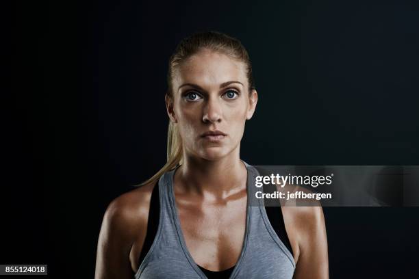 focused on getting and staying fit - blonde hair black background stock pictures, royalty-free photos & images