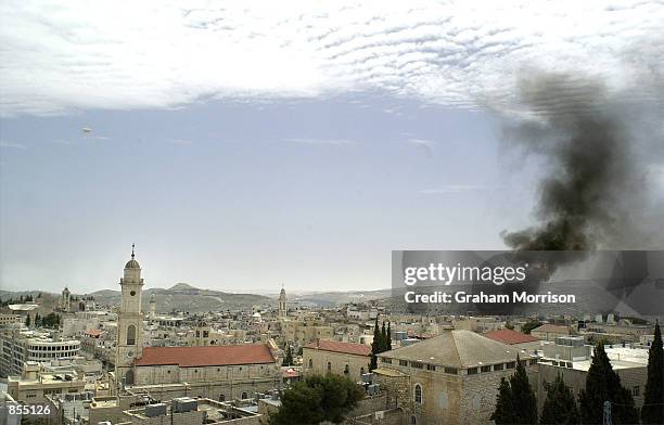 Black smoke is seen rising April 13, 2002 over the Palestinian West Bank city of Bethlehem. Over 200 people have taken shelter inside the Church of...