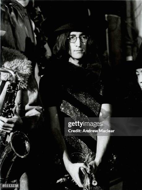 Photo of John LENNON; while in The Beatles, posed on the set of 'Rock 'n' Roll Circus'