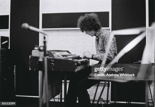 Photo of PINK FLOYD; Syd Barrett playing keyboards in the recording studio