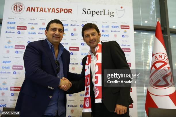 Former Brazilian player and head coach Leonardo Nascimento de Araujo shakes hands with President of Antalyaspor Ali Safak Ozturk after signing for...