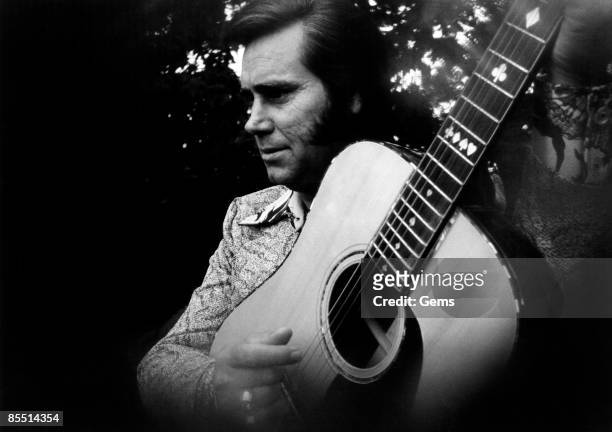 Circa 1975: Photo of Country musician George JONES posed playing an acoustic guitar circa 1975.