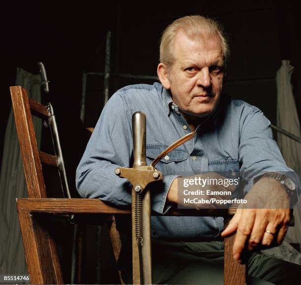 English opera singer and baritone Sir Thomas Allen seated in the electric chair prop on the set of the Neil Armfield production of the musical...