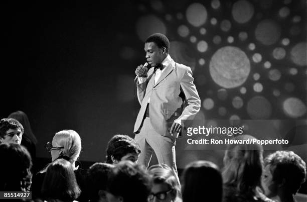 Jamaican singer Desmond Dekker performs on the set of a pop music television show in London circa 1967.