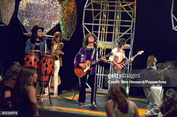 English rock band T. Rex perform on the set of a pop music television show in London in February 1971. Members of the group are, from left, Mickey...
