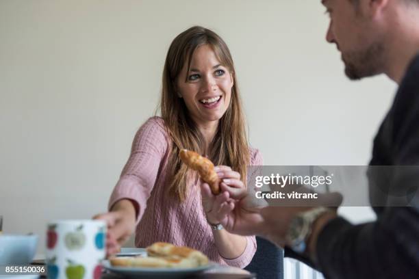 young couple having breakfast - marmalade sandwich stock pictures, royalty-free photos & images