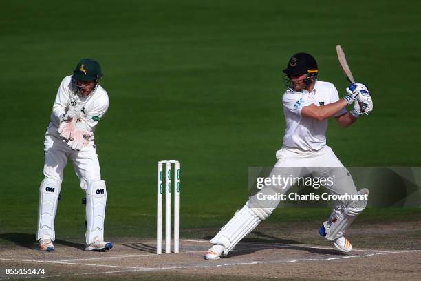 Laurie Evans of Sussex hits out while Nottingham keepers Chris Read looks on during day four of the Specsavers County Championship Division Two match...