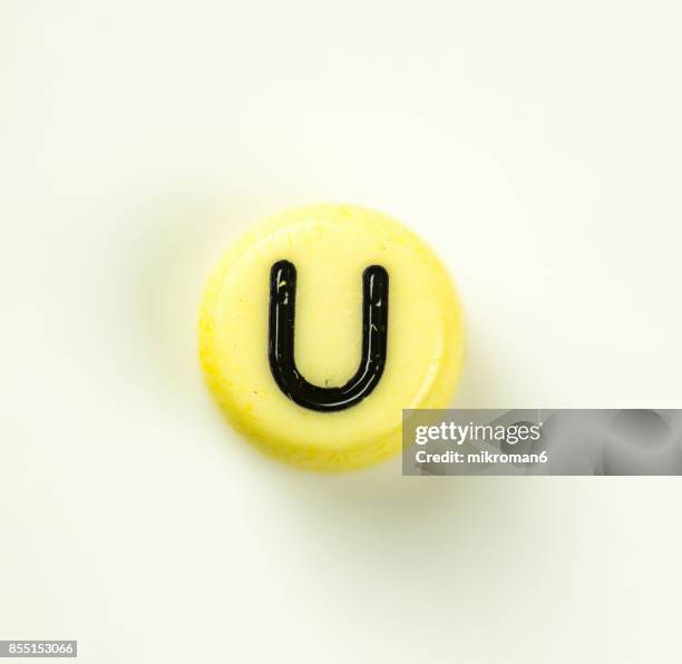 directly above shot of plastic capital letter u on white background - letter u stock pictures, royalty-free photos & images