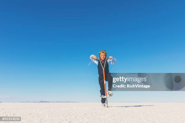 business-boy auf salinen mit pogo stick - pogo stock-fotos und bilder