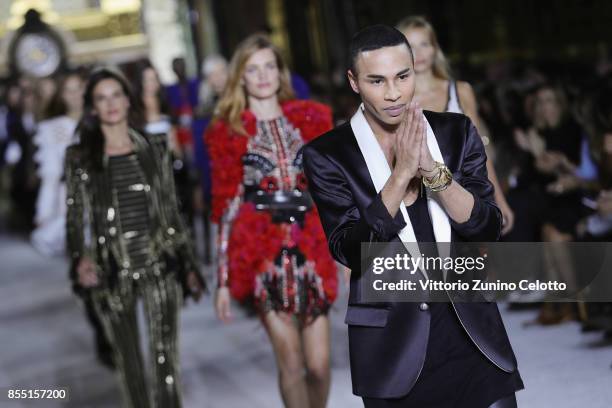 Designer Olivier Rousteing and models Alessandra Ambrosio, Natasha Poly and Natalia Vodianova acknowledge the applause of the public after the...