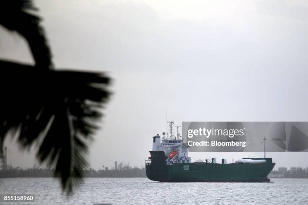 Cargo ship travels from the Isla Grande Port in San Juan, Puerto Rico, on Wednesday, Sept. 27, 2017. Trump ordered the Jones Act to be waived for...