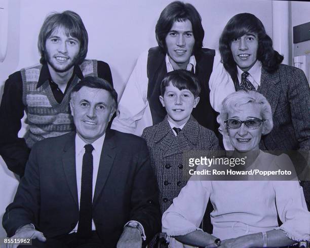 From left, Maurice Gibb , father Hugh Gibb , Andy Gibb in front, Barry Gibb , Robin Gibb and mother Barbara Gibb posed backstage in London circa...
