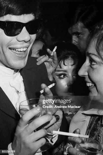 Photo of 60's; Clubber inside The Revolution Club, sunglasses and smoking cigarette