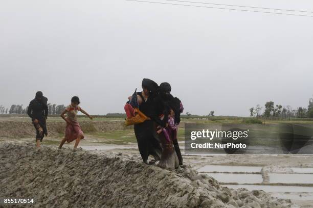 Rohingya refugees walk toward refugee camp after crosses Myanmar-Bangladesh border at Teknaf in Bangldesh on September 28, 2017. Violence erupted in...