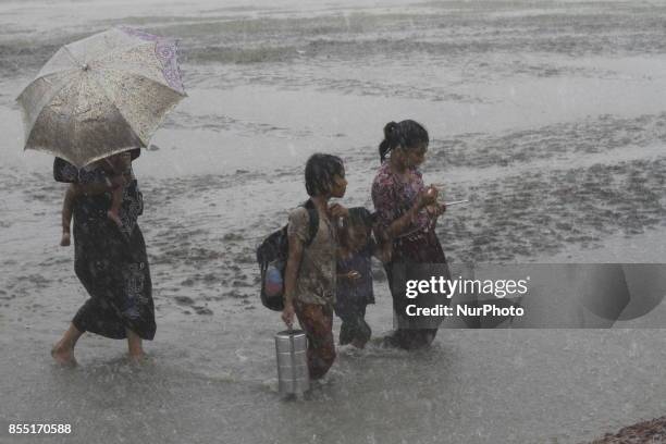 Rohingya refugees walk toward refugee camp after crosses Myanmar-Bangladesh border at Teknaf in Bangldesh on September 28, 2017. Violence erupted in...