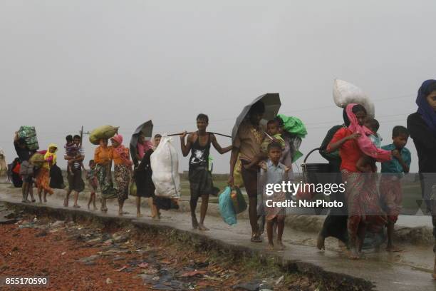 Rohingya refugees walk toward refugee camp after crosses Myanmar-Bangladesh border at Teknaf in Bangldesh on September 28, 2017. Violence erupted in...