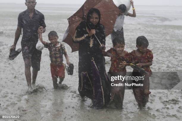 Rohingya refugees walk toward refugee camp after crosses Myanmar-Bangladesh border at Teknaf in Bangldesh on September 28, 2017. Violence erupted in...