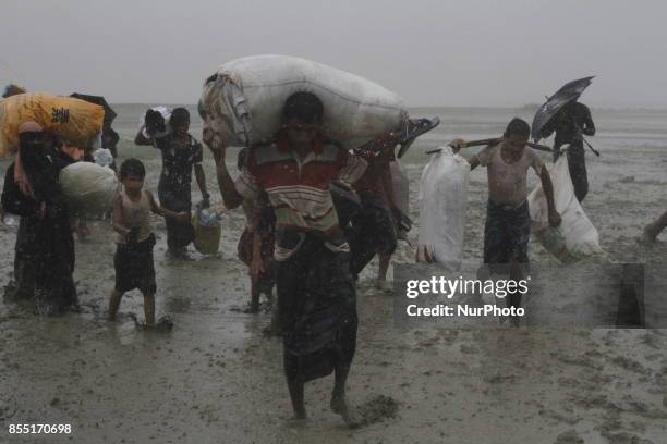 Rohingya refugees walk toward refugee camp after crosses Myanmar-Bangladesh border at Teknaf in Bangldesh on September 28, 2017. Violence erupted in...