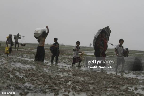 Rohingya refugees walk toward refugee camp after crosses Myanmar-Bangladesh border at Teknaf in Bangldesh on September 28, 2017. Violence erupted in...