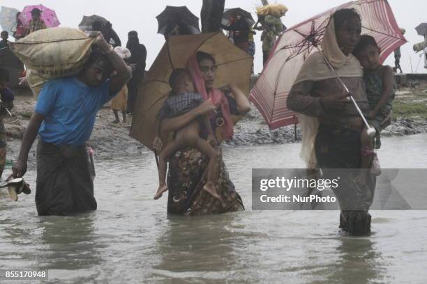 Rohingya refugees walk toward refugee camp after crosses Myanmar-Bangladesh border at Teknaf in Bangldesh on September 28, 2017. Violence erupted in...