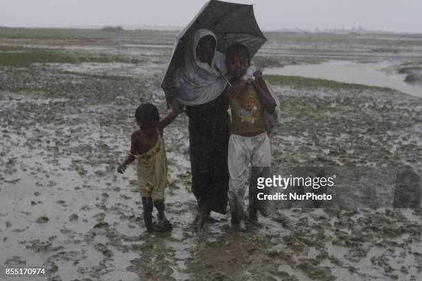 Rohingya refugees walk toward refugee camp after crosses Myanmar-Bangladesh border at Teknaf in Bangldesh on September 28, 2017. Violence erupted in...