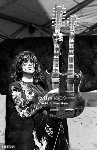 Photo of Jimmy PAGE and LED ZEPPELIN, Jimmy Page performing on stage, playing a Gibson EDS-1275 twin necked guitar