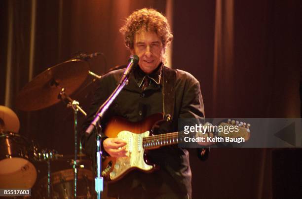 Photo of Bob DYLAN; Bob Dylan performing on stage, sunglasses