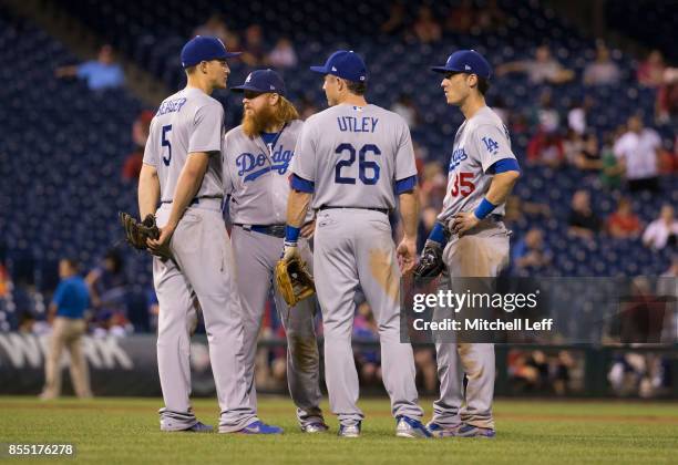 Corey Seager, Justin Turner, Chase Utley, and Cody Bellinger of the Los Angeles Dodgers huddle against the Philadelphia Phillies at Citizens Bank...